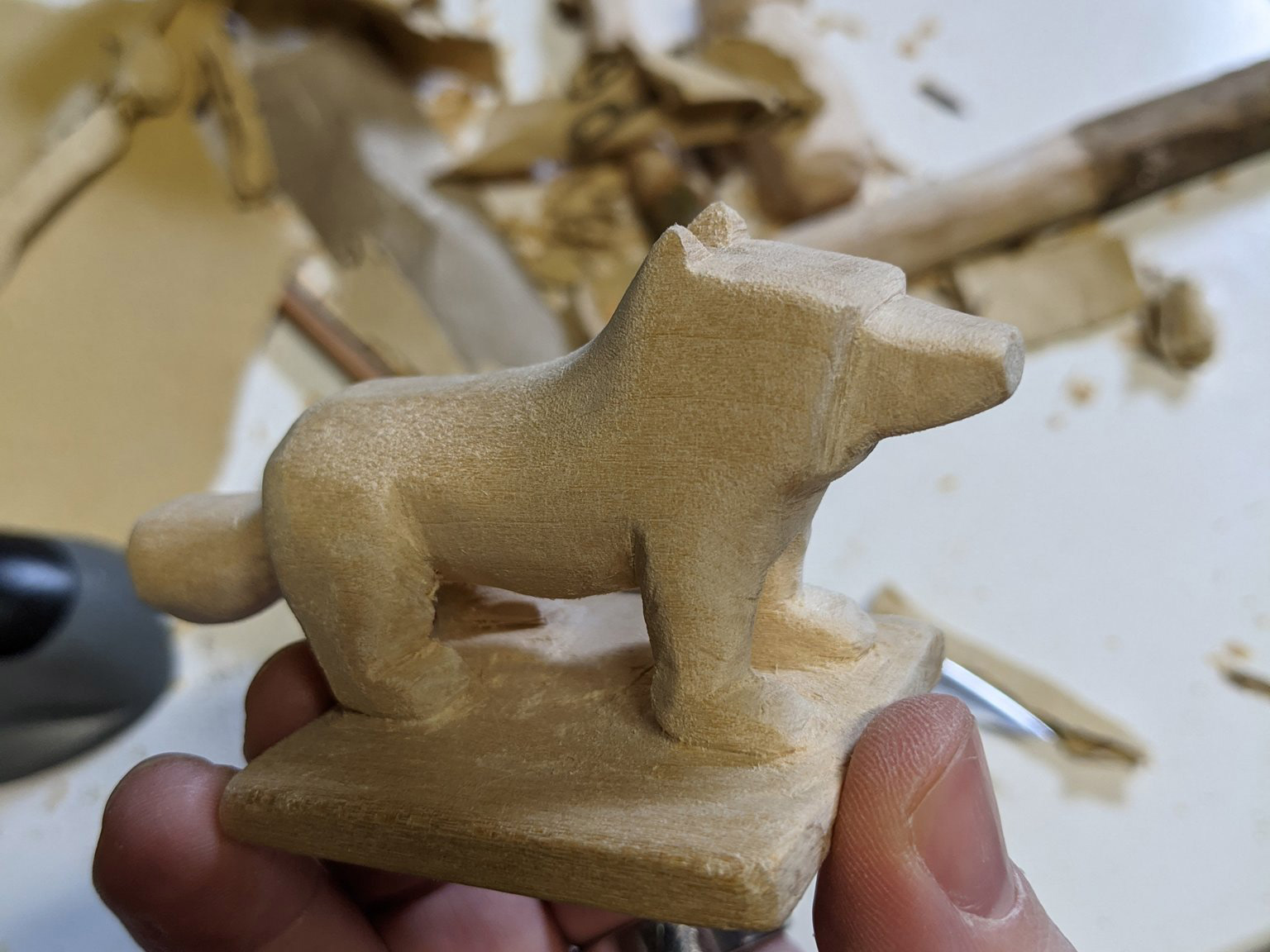 Holding the dog to the side, fully formed and beginning to be smoothed out