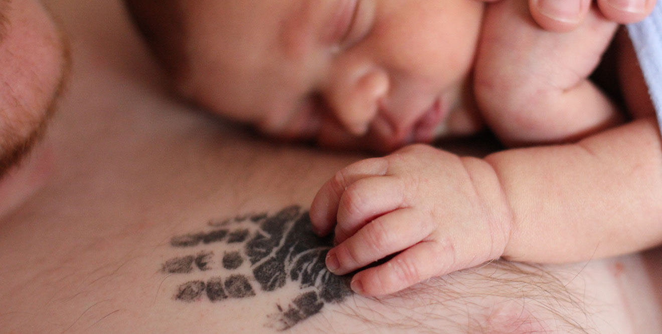 Ellis' hand rests on Tia's hand print