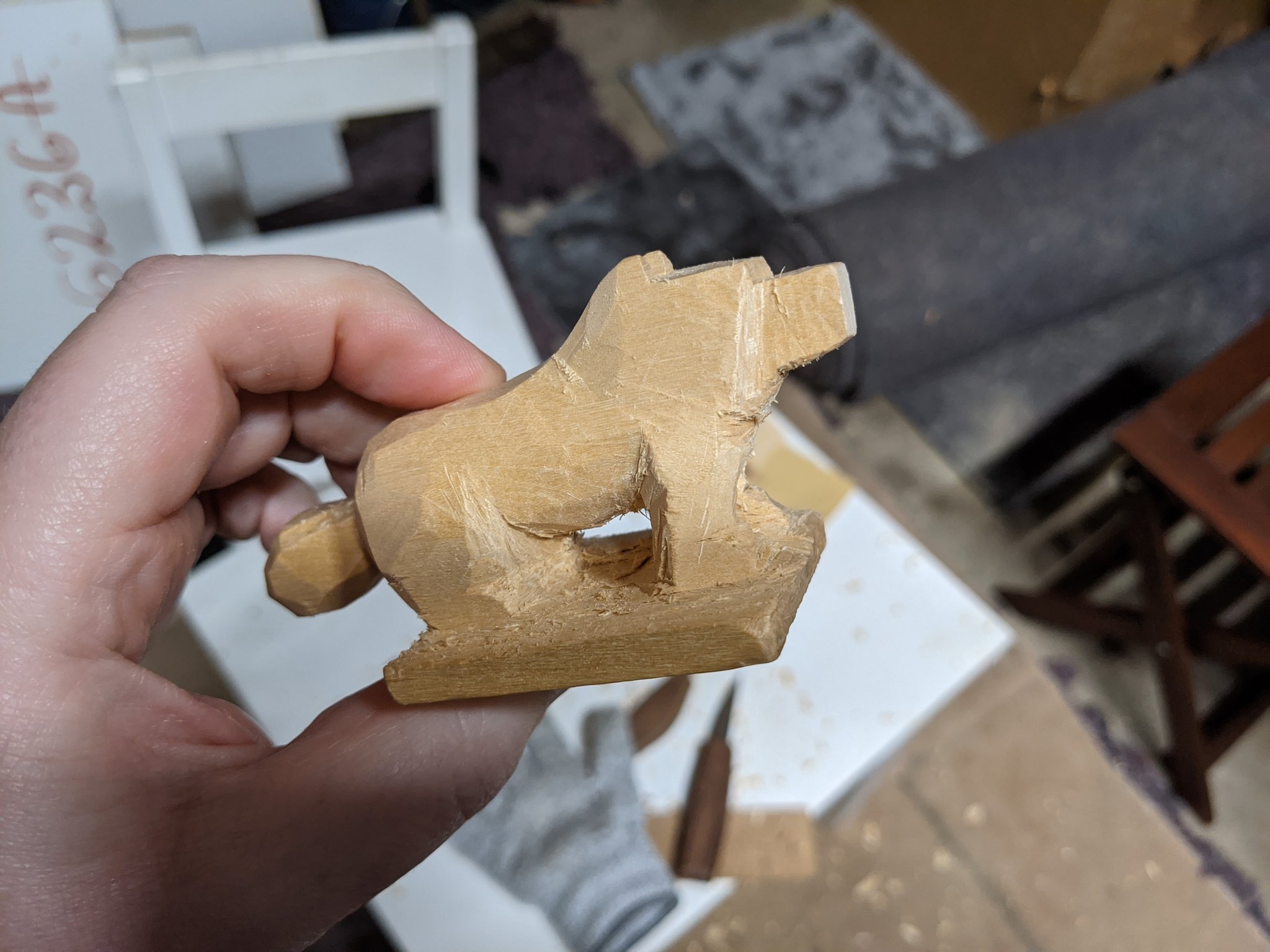 Side view of the dog, clearly standing on it's wooden platform, still rough cuts, but a clear view under the dog's belly. Though looks like you'd catch a splinter if you weren't careful